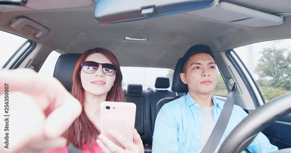 couple use phone in car