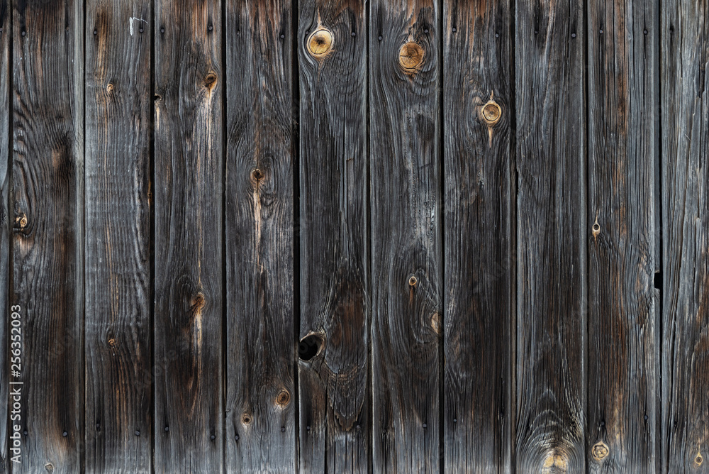 The texture of the old wooden fence dark color The texture of the old wooden fence dark color