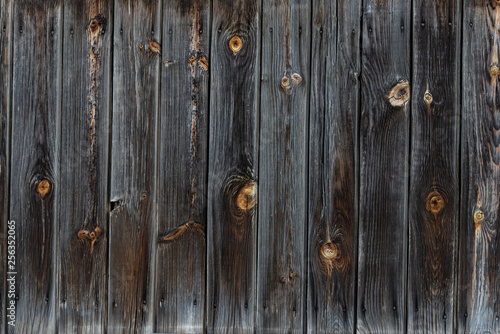 The texture of the old wooden fence dark color