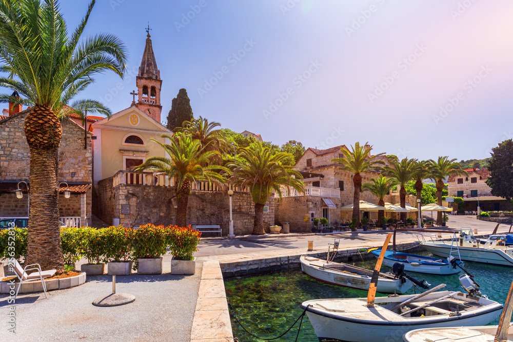 Fototapeta premium Fishing boats in Splitska village with beautiful port, Brac island, Croatia. Village of Splitska on Brac island seafront view, Dalmatia, Croatia, Croatia.