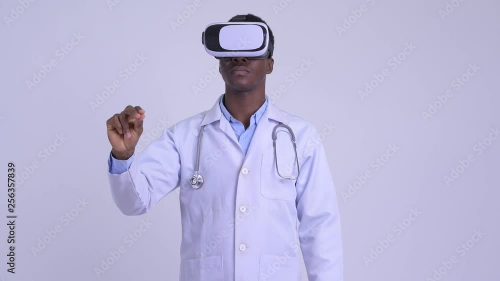 Young African man doctor using virtual reality headset Young African man doctor using virtual reality headset