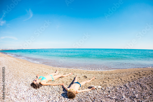 Fototapeta Naklejka Na Ścianę i Meble -  The boy with his mother sunbathe on the beach.