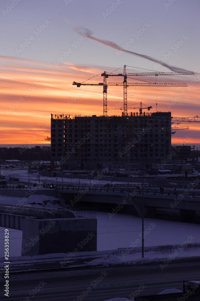 Naklejka premium Industrial construction cranes and building silhouettes