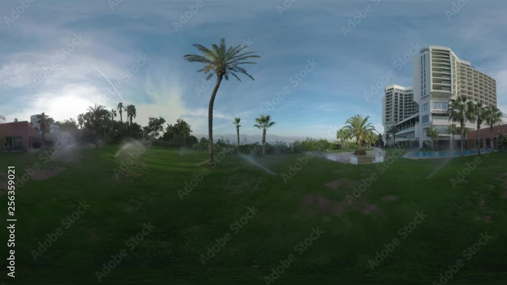 360 VR video. Hotel with picturesque view to sea and mountains. Morning scene with watering green areas and palms. Holiday in Antalya, Turkey 360 VR video. Hotel with picturesque view to sea and mountains. Morning scene with watering green areas and palms. Holiday in Antalya, Turkey