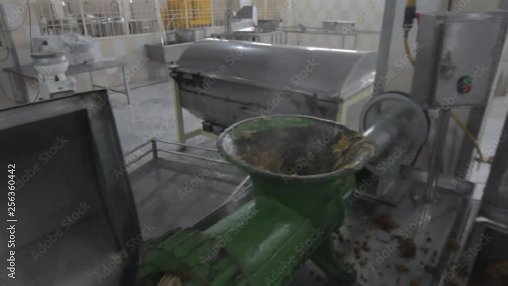 Ready Meal Production line in a factory, A man shifting cooked rice into a machine that mincing it Ready Meal Production line in a factory, A man shifting cooked rice into a machine that mincing it