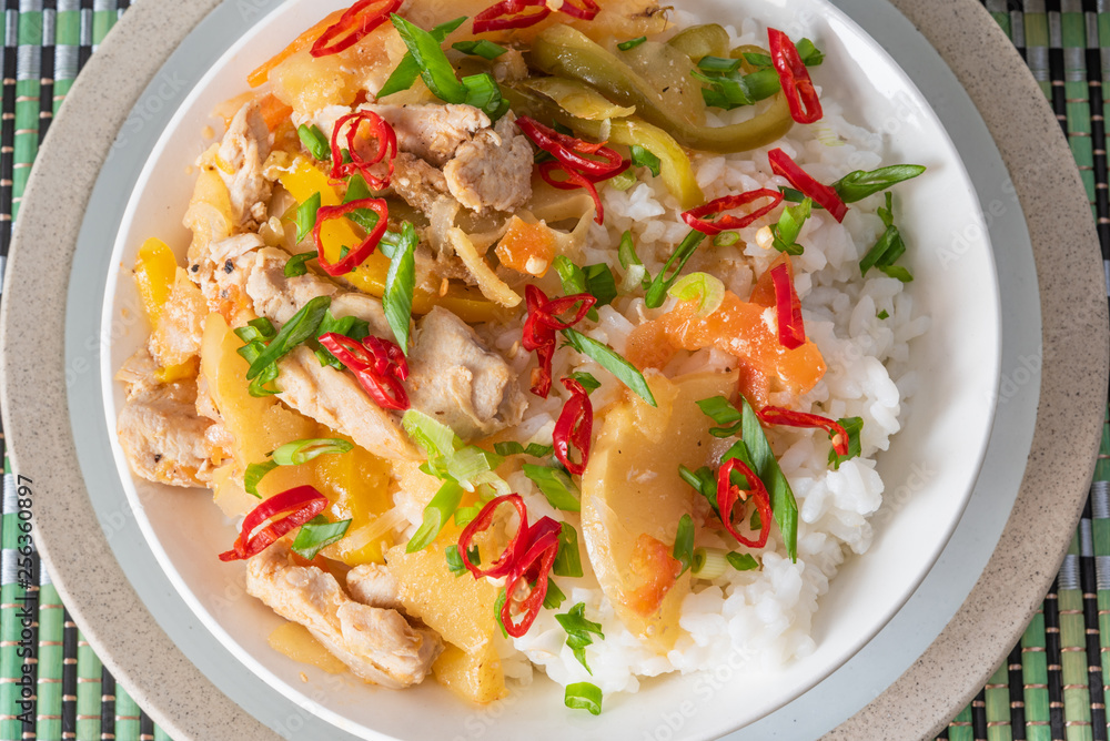 Curry of chicken and apples with rice in a bowl, top view - Asian cuisine.