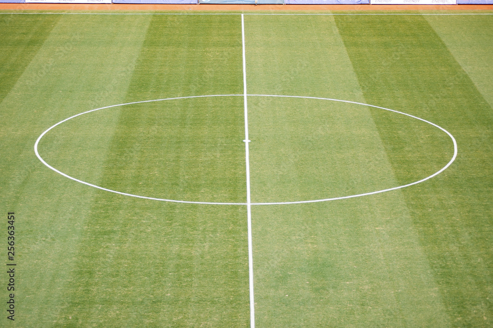 Aerial view of natural beautiful pattern of fresh green grass soccer field background. Football stadium.