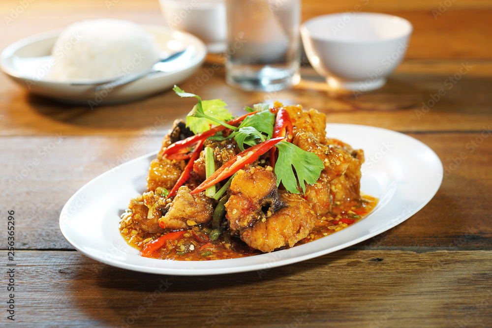 Fried fish with sweet chilli sauce served with steamed rice, Selective focus. Still life shoot in studio, Clean food good taste idea concept. Fried fish with sweet chilli sauce served with steamed rice, Selective focus. Still life shoot in studio, Clean food good taste idea concept.