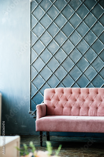 Pink sofa on blue wall background