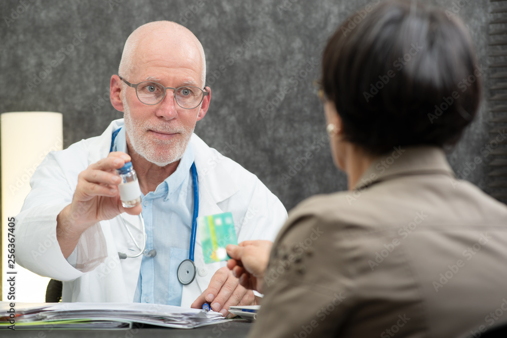 patient paying doctor with health insurance card patient paying doctor with health insurance card