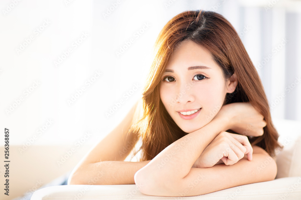 Young beautiful woman sitting on sofa Young beautiful woman sitting on sofa