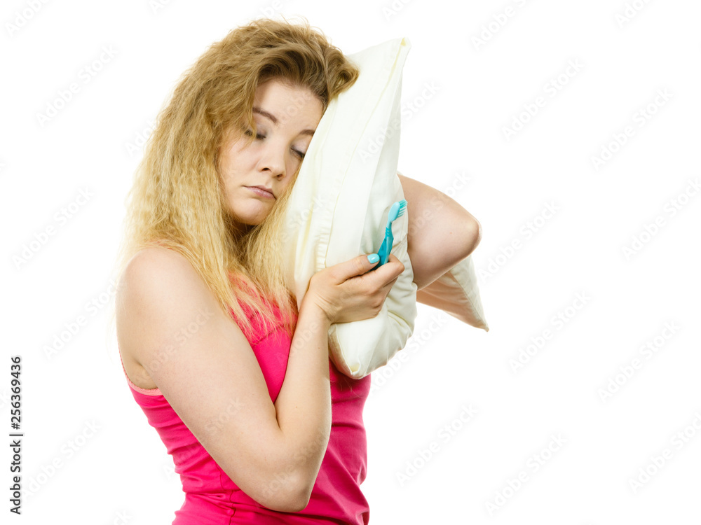 Sleepy woman hugging white pillow