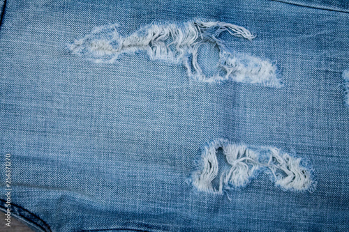 Blue Jean texture with a hole and threads.