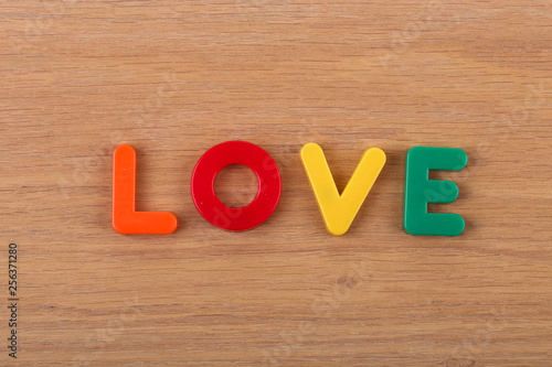 The word LOVE is laid out from colored plastic letters