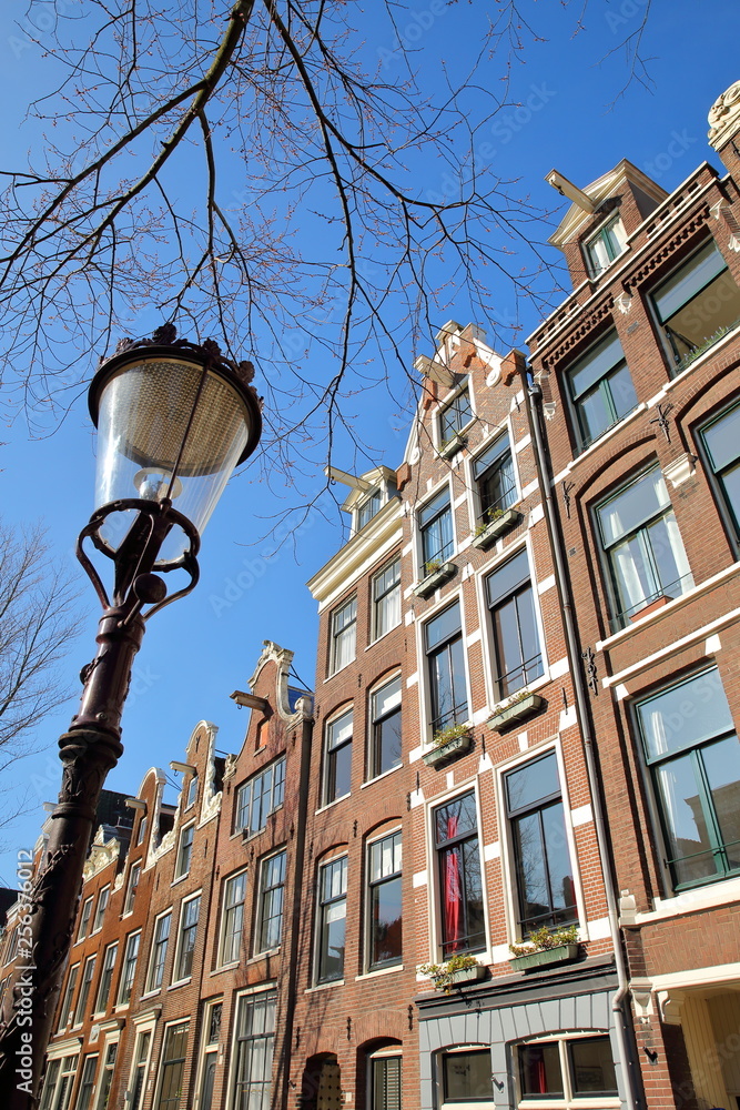 Crooked and colorful heritage buildings, located along Bloemgracht Canal in Jordaan, Amsterdam, Netherlands