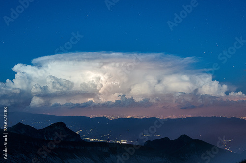 Thunderstorm under a starry sky over Conegliano city 