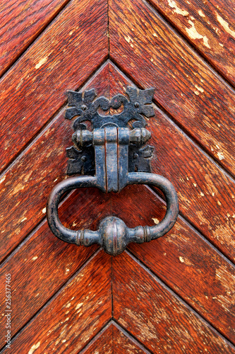 Vintage doorknocker close-up on wooden door background