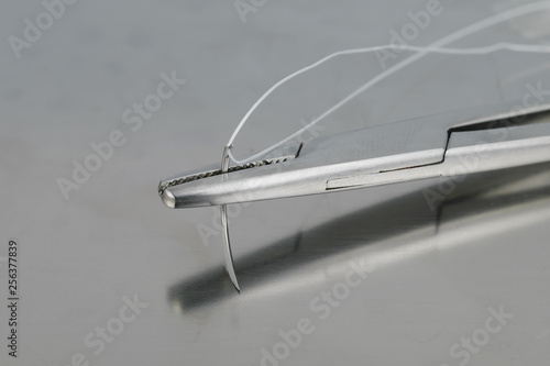 Needle holder with surgical needle.