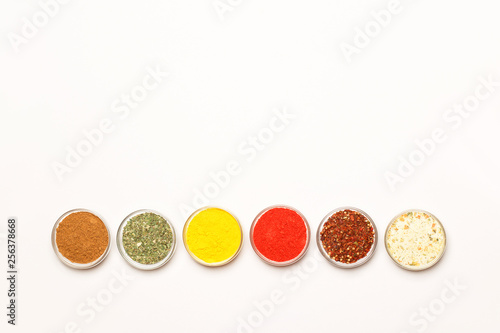 Condiments and herbs on white background. Flat lay. Top view.