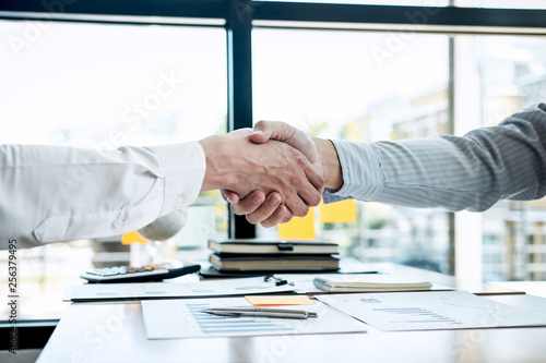 Finishing up a conversation after collaboration, handshake of two business people after contract agreement to become a partner, collaborative teamwork