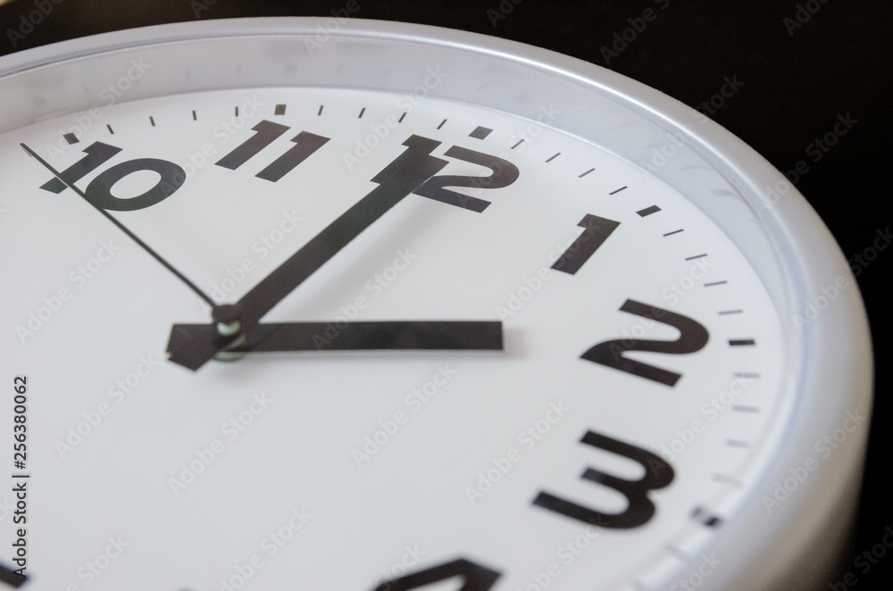 Close up of black and white analog clock with selective focus at 2 Oclock. Time concept Close up of black and white analog clock with selective focus at 2 Oclock. Time concept