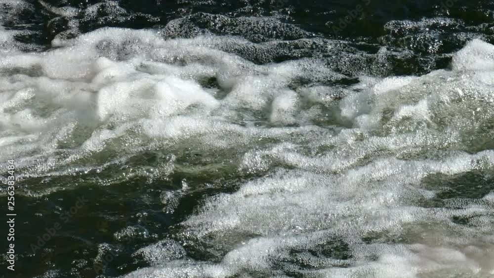 Rushing foamy water. Fast-running stream Rushing foamy water. Fast-running stream