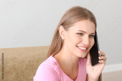 Young woman with hearing ai...
