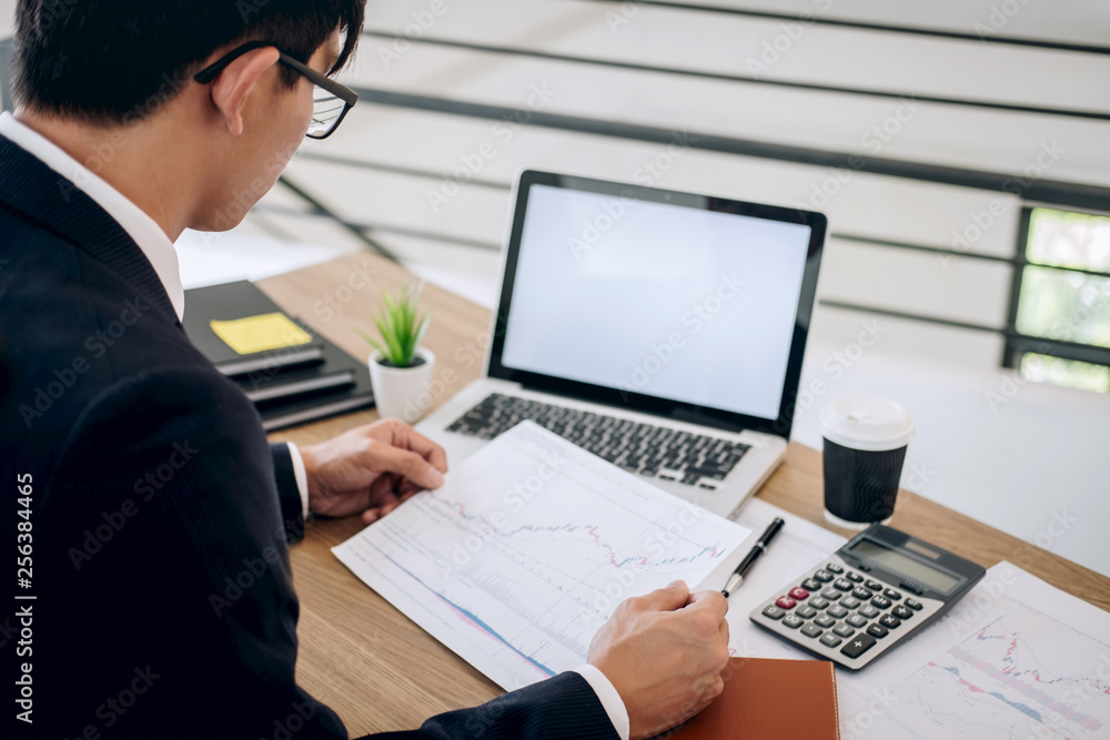 Businessman working new project on laptop computer with report document and analyze, calculating financial data on graph documents, doing finance making notes statistics Businessman working new project on laptop computer with report document and analyze, calculating financial data on graph documents, doing finance making notes statistics