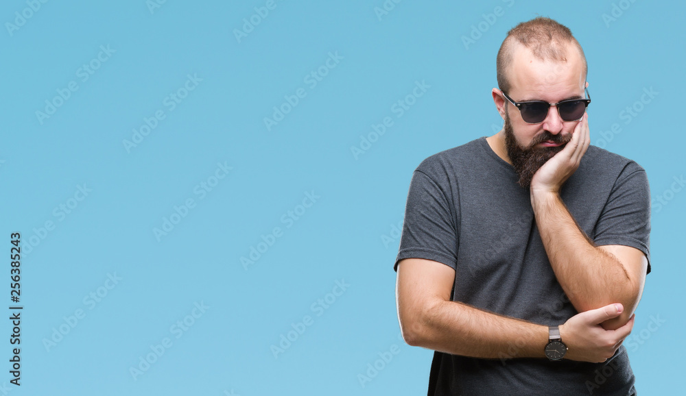 Young caucasian hipster man wearing sunglasses over isolated background thinking looking tired and bored with depression problems with crossed arms. Young caucasian hipster man wearing sunglasses over isolated background thinking looking tired and bored with depression problems with crossed arms.