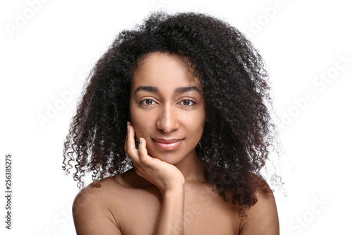 Young African-American woman on white background