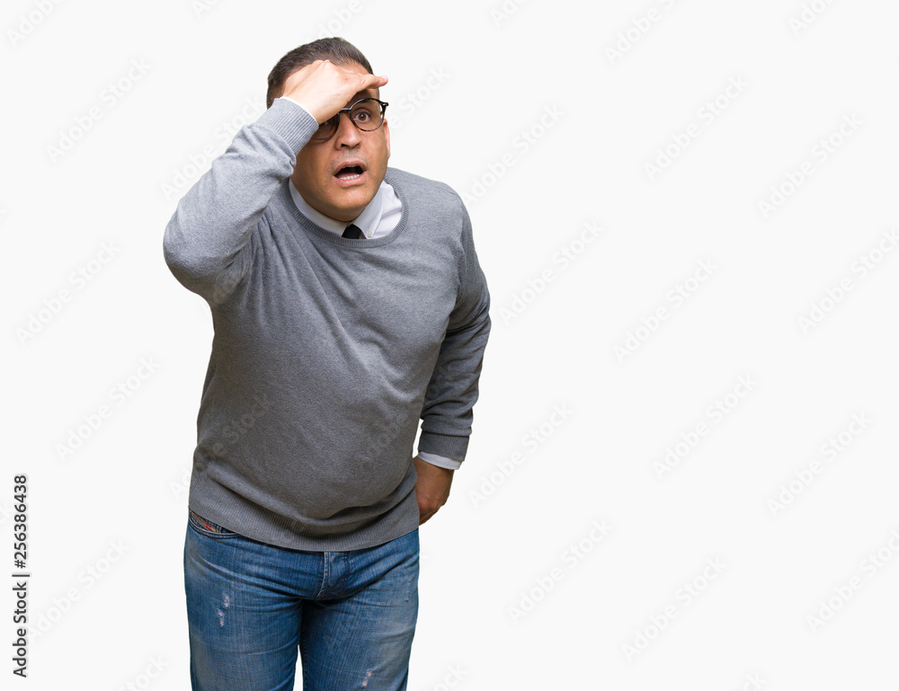 Middle age bussines arab man wearing glasses over isolated background very happy and smiling looking far away with hand over head. Searching concept. Middle age bussines arab man wearing glasses over isolated background very happy and smiling looking far away with hand over head. Searching concept.