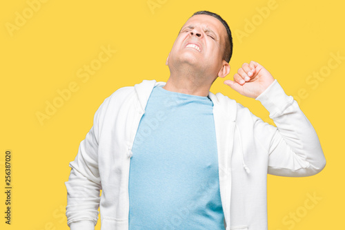Middle age arab man wearing sweatshirt over isolated background stretching back  tired and relaxed  sleepy and yawning for early morning