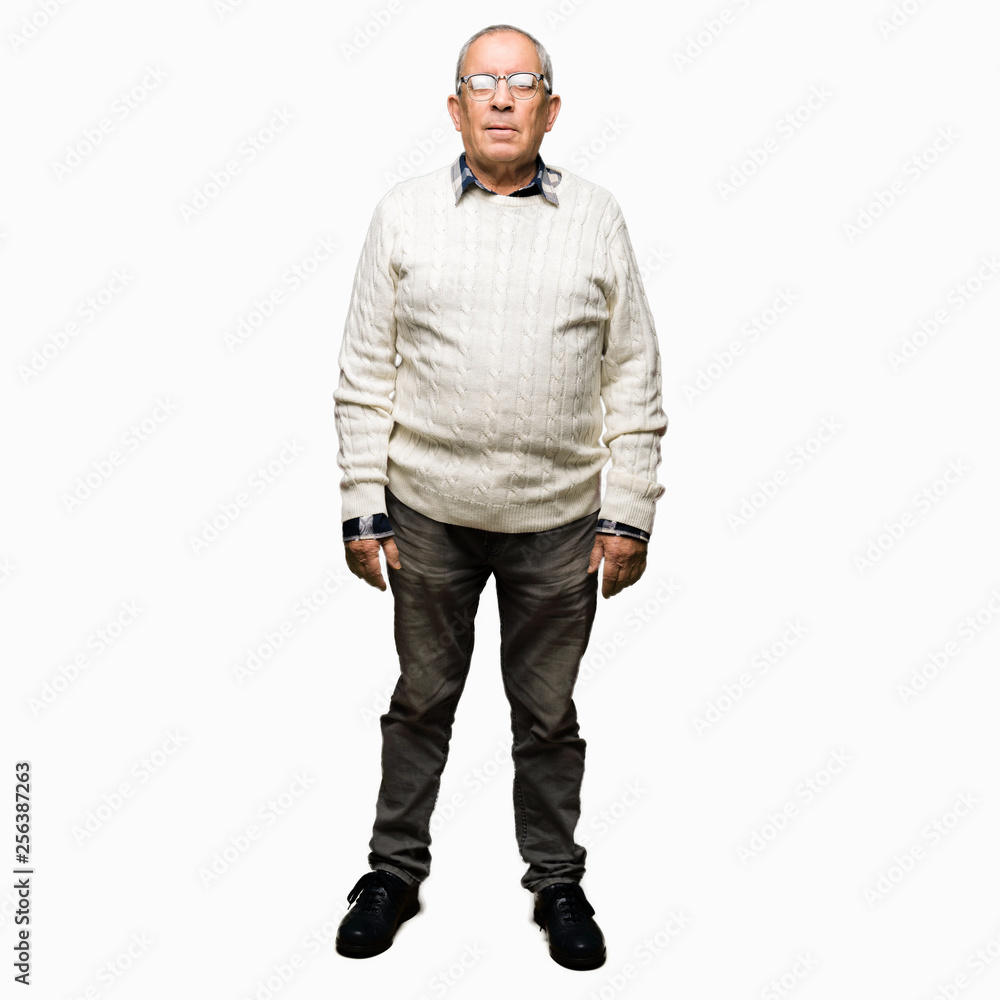 Handsome senior man wearing glasses and winter sweater with serious expression on face. Simple and natural looking at the camera. Handsome senior man wearing glasses and winter sweater with serious expression on face. Simple and natural looking at the camera.