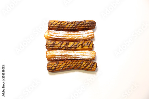 spanish chocolate and sugar fritters with white background