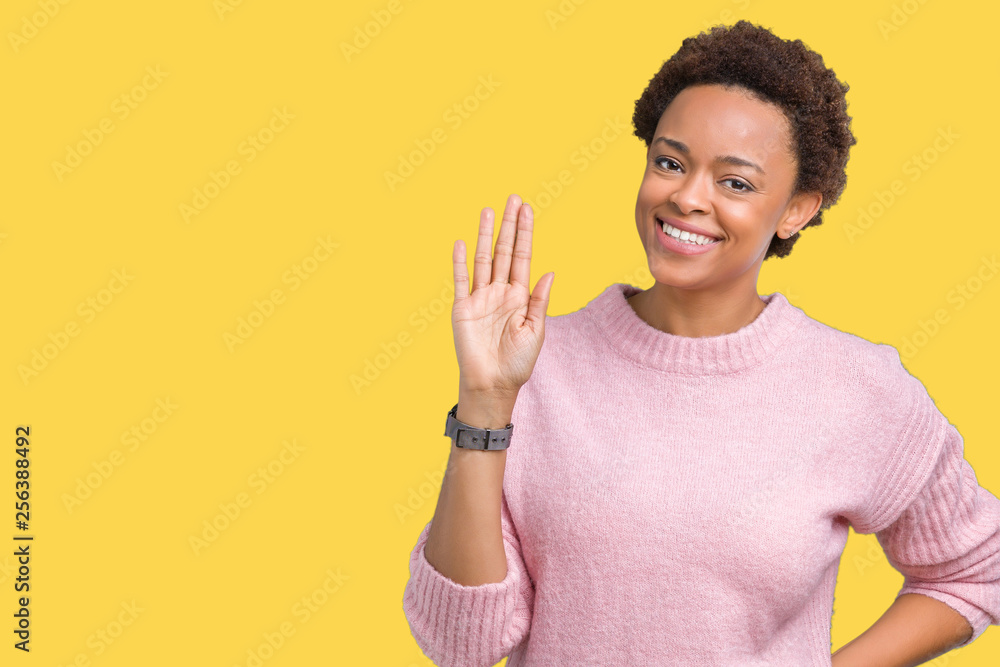 Beautiful young african american woman over isolated background Waiving saying hello happy and smiling, friendly welcome gesture Beautiful young african american woman over isolated background Waiving saying hello happy and smiling, friendly welcome gesture