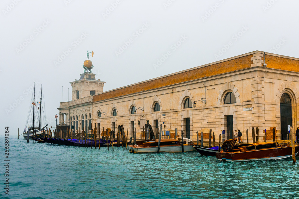 Venice / Italy 19 february 2019 :historic building and a big Sailing boat at venice docks photo taken from 
