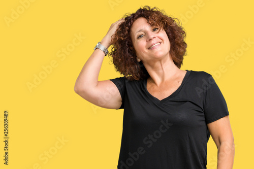 Beautiful middle ager senior woman over isolated background Smiling confident touching hair with hand up gesture, posing attractive