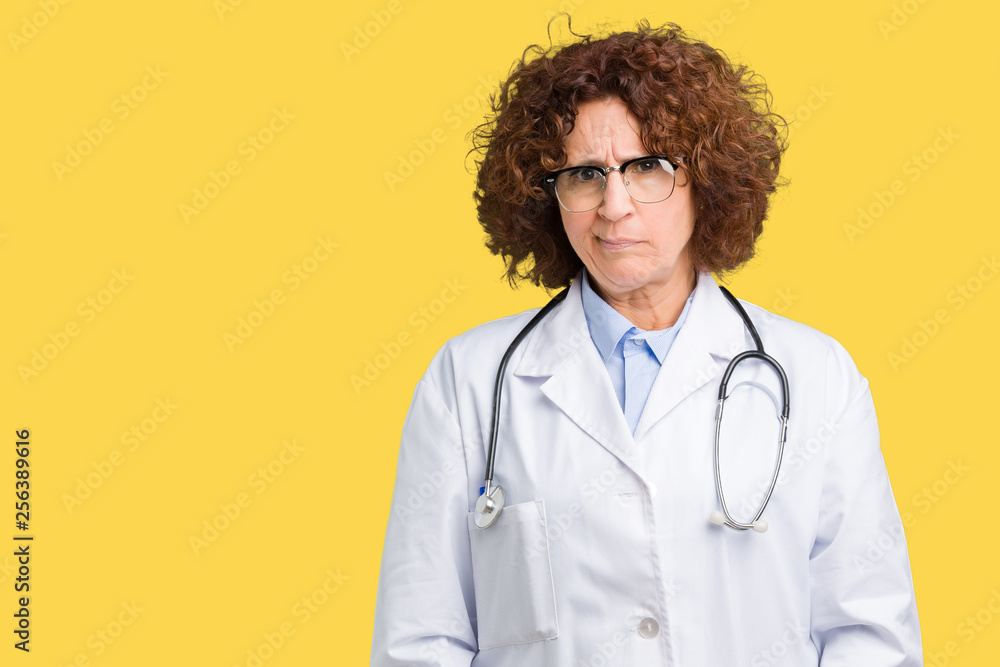 Middle ager senior doctor woman over isolated background skeptic and nervous, frowning upset because of problem. Negative person. Middle ager senior doctor woman over isolated background skeptic and nervous, frowning upset because of problem. Negative person.