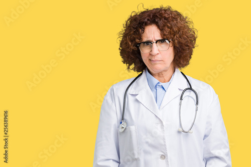 Принти на полотні Middle ager senior doctor woman over isolated background skeptic and nervous, frowning upset because of problem