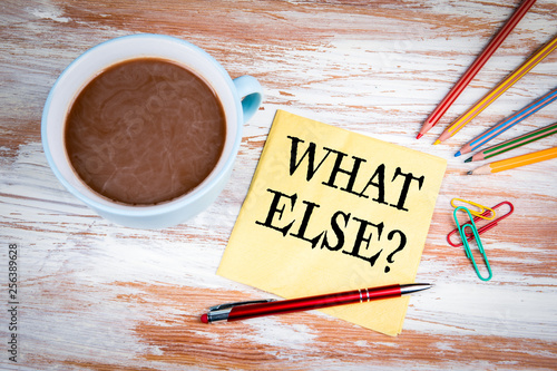 What Else. Text on a napkin with a cup of coffee