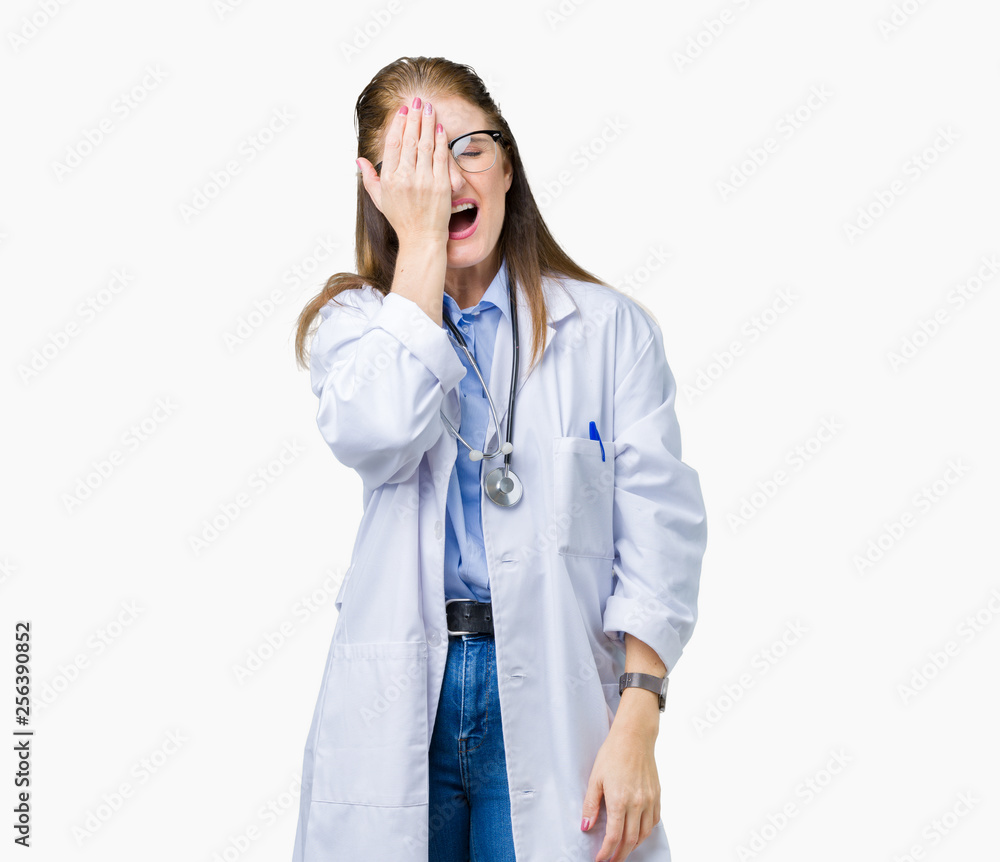 Middle age mature doctor woman wearing medical coat over isolated background Yawning tired covering half face, eye and mouth with hand. Face hurts in pain. Middle age mature doctor woman wearing medical coat over isolated background Yawning tired covering half face, eye and mouth with hand. Face hurts in pain.
