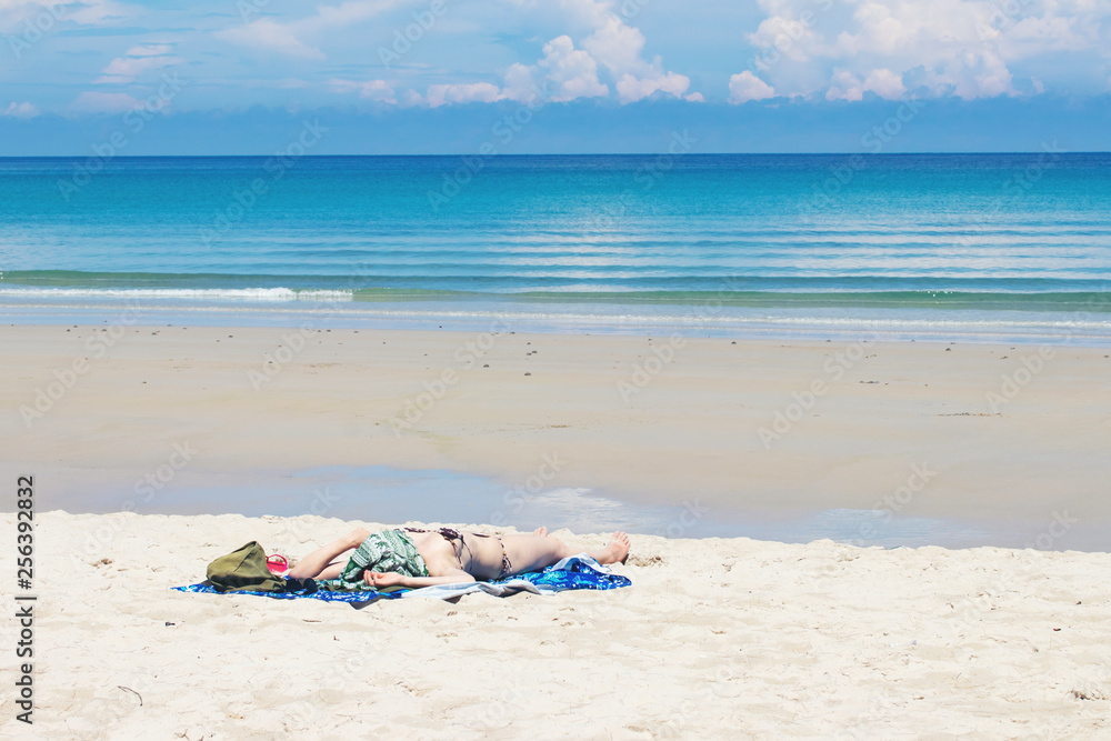 Beautiful caucasian woman sunbathing on the beach.Young woman resting on sand at tropical beach. Beautiful caucasian woman sunbathing on the beach.Young woman resting on sand at tropical beach.