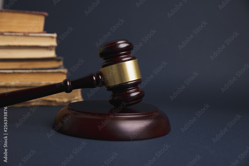 Judge gavel with Justice lawyers having team meeting at law firm in background. Judge gavel with Justice lawyers having team meeting at law firm in background.