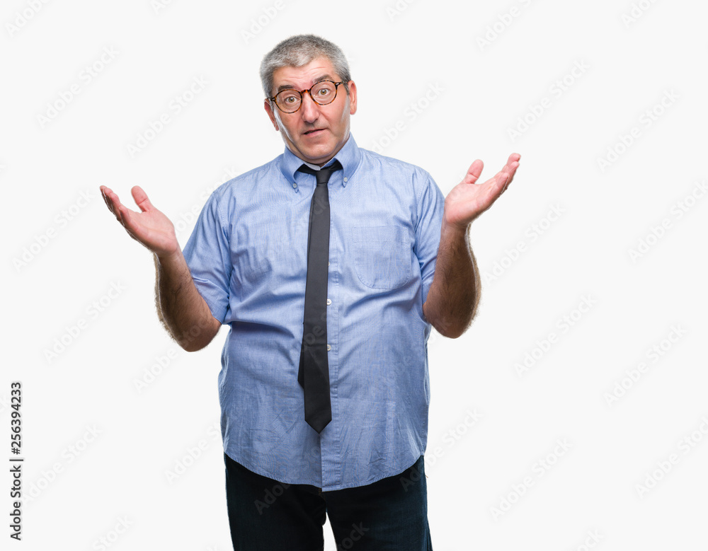 Handsome senior business man over isolated background clueless and confused expression with arms and hands raised. Doubt concept. Handsome senior business man over isolated background clueless and confused expression with arms and hands raised. Doubt concept.