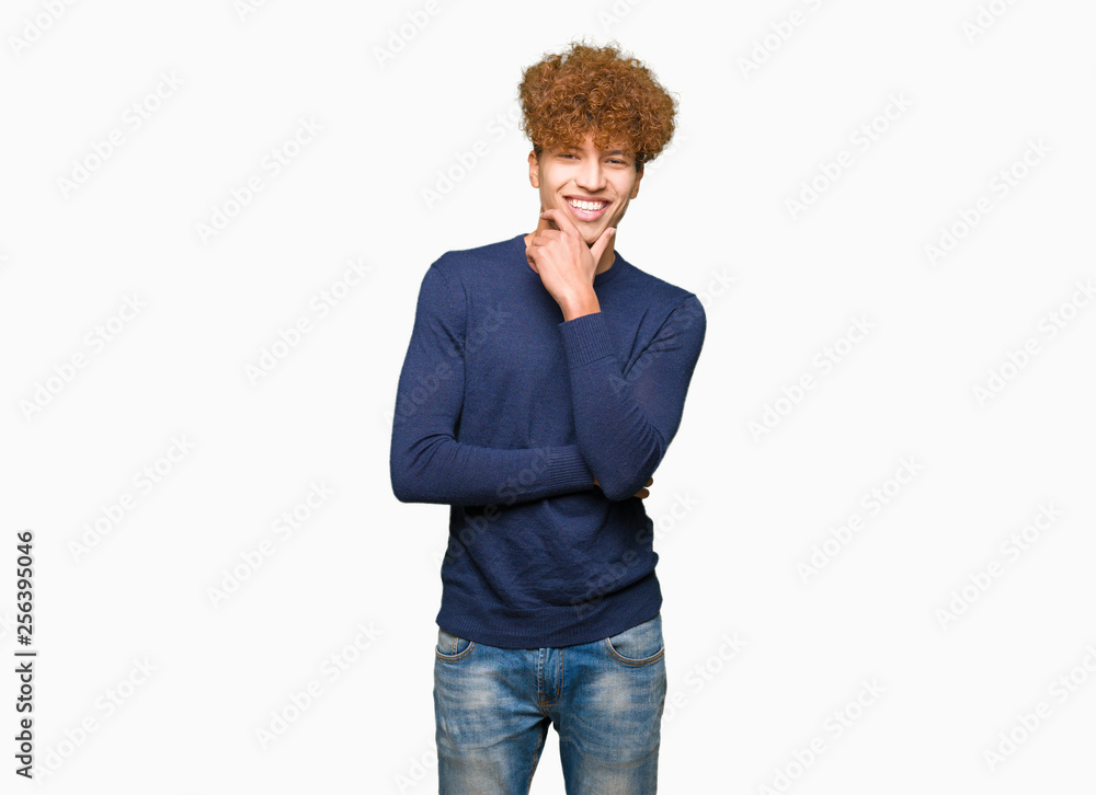 Young handsome man with afro hair looking confident at the camera with smile with crossed arms and hand raised on chin. Thinking positive. Young handsome man with afro hair looking confident at the camera with smile with crossed arms and hand raised on chin. Thinking positive.