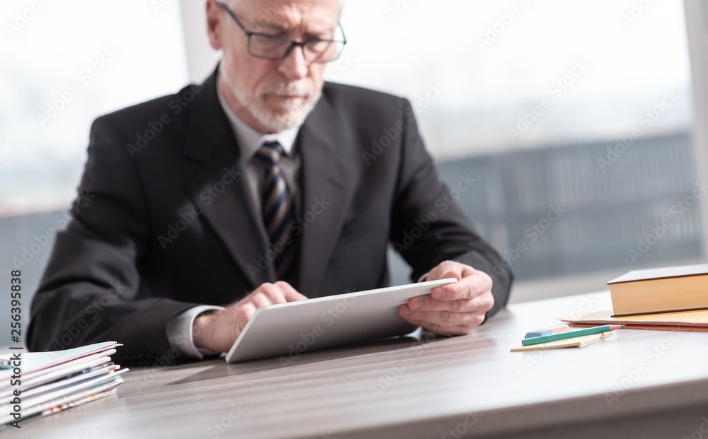Senior businessman using a digital tablet Senior businessman using a digital tablet