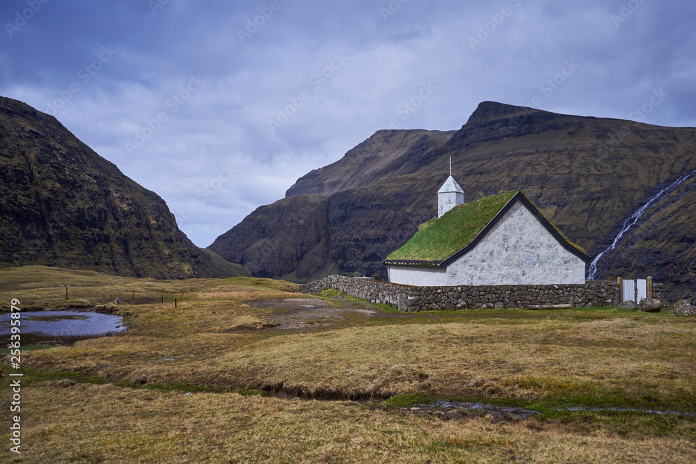 Mediaeval church with grass or turf roof in village Saksun or danish Saksen near the northwest coast of the Faroese island of Streymoy, in Sunda Municipality. Picture is taken in cloudy spring morning Mediaeval church with grass or turf roof in village Saksun or danish Saksen near the northwest coast of the Faroese island of Streymoy, in Sunda Municipality. Picture is taken in cloudy spring morning