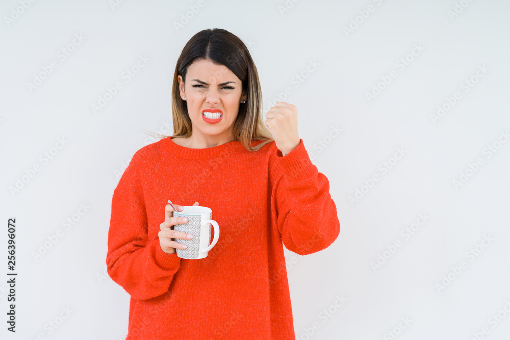 Young woman drinking cup of coffee over isolated background annoyed and frustrated shouting with anger, crazy and yelling with raised hand, anger concept Young woman drinking cup of coffee over isolated background annoyed and frustrated shouting with anger, crazy and yelling with raised hand, anger concept