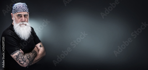 studio portrait of a senior hipster with a long white beard