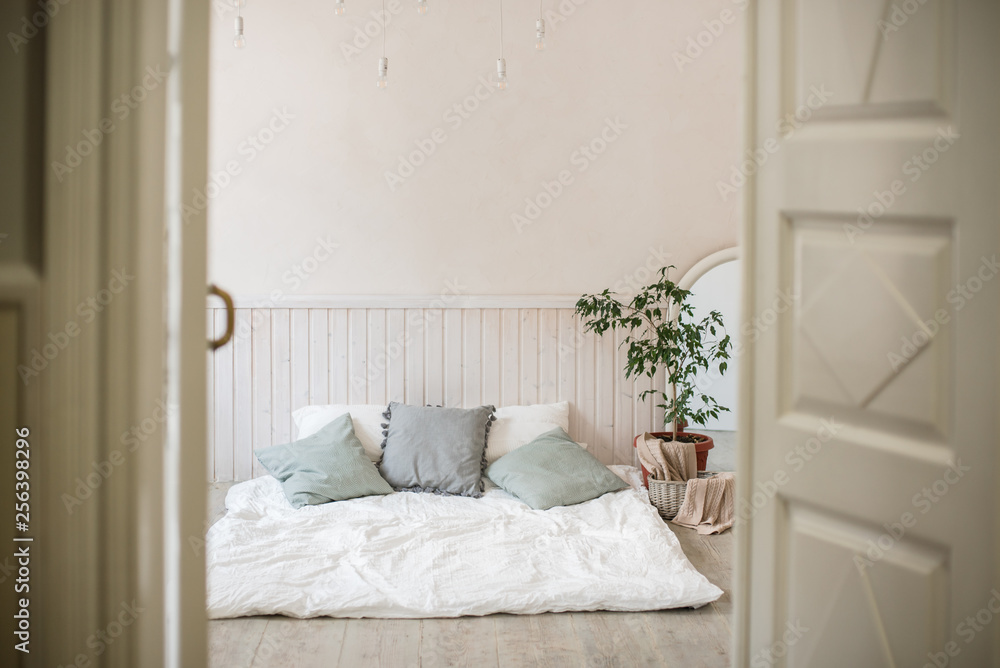 The bed on the floor and the ficus next to it. The bed on the floor and the ficus next to it.